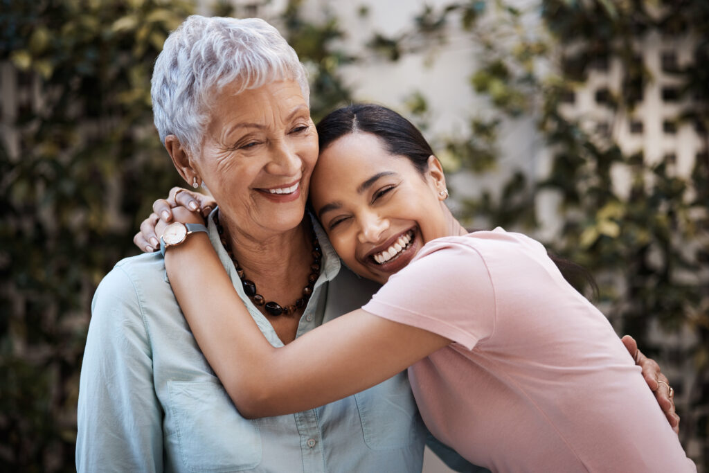 Happy, hug and portrait of a mother and woman in a garden on mothers day with love and gratitude. Smile, family and an adult daughter hugging a senior mom in a backyard or park for happiness.