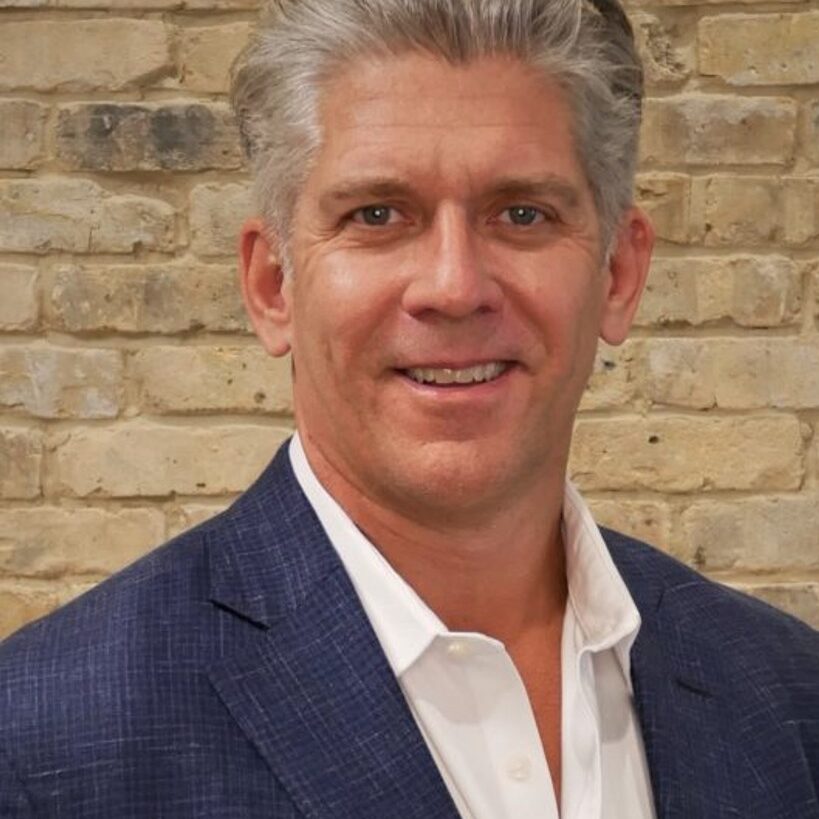 Headshot image of Darren Gee wearing a blue sportscoat and white shirt